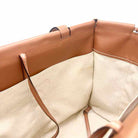 Interior view of Loewe Cushion Tote handbag with leather trim and canvas lining, showcasing spacious design.